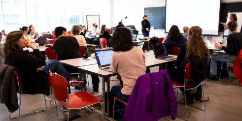 group in a classroom listening to a speaker